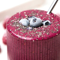 Berry superfood smoothie topped with blueberries and chia seeds